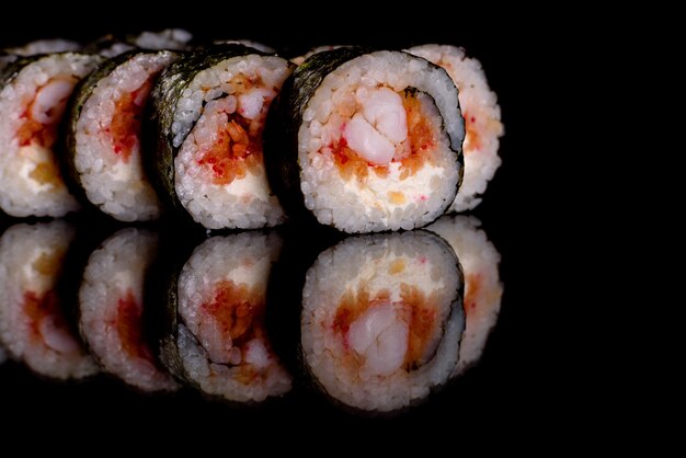 Frisches köstliches Sushi rollt auf einem dunklen Hintergrund