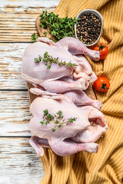 Frisches rohes Huhn mit Gewürzen, kochendem Hintergrund auf Weiß. Draufsicht