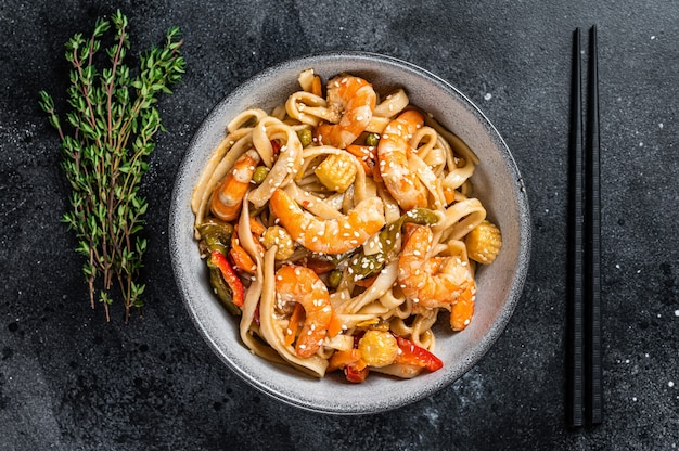 Frite macarrão udon de frutos do mar com camarão camarão em uma tigela