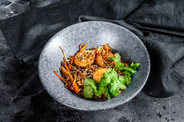 Frite o macarrão de arroz com camarões e vegetais. Asia wok