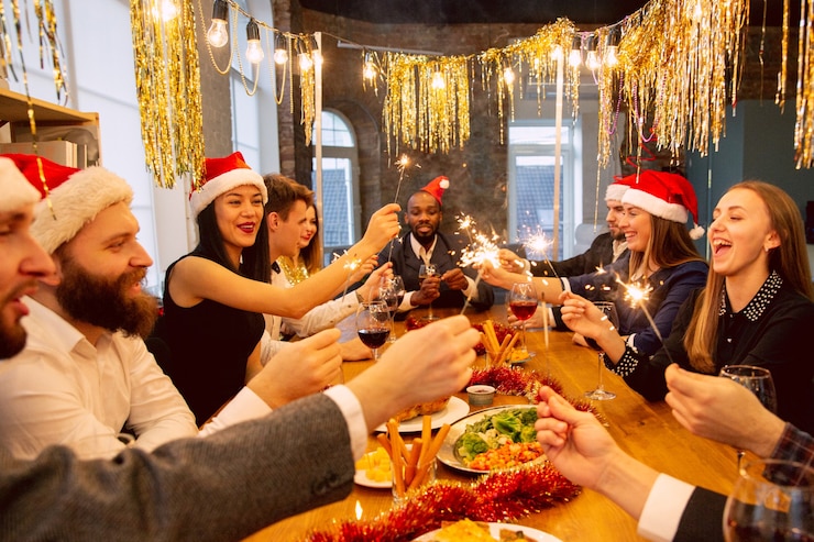 Foto fröhliche mitarbeiter, die während der firmenfeier für silvester und weihnachten feiern