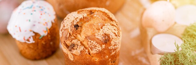 Foto fröhliche osterferien in der frühlingssaison natürlicher hausgemachter gebackener kuchen und bemalte eier auf holzbrett tisch festliche wohnkultur traditionelles essen land rustikal tablscape stil fahnenfackel