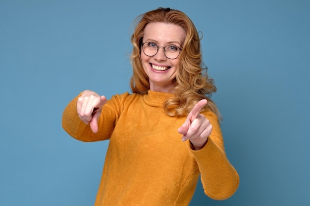 Fröhliche reife Frau mit Brille, die auf dich zeigt, ich wähle dich