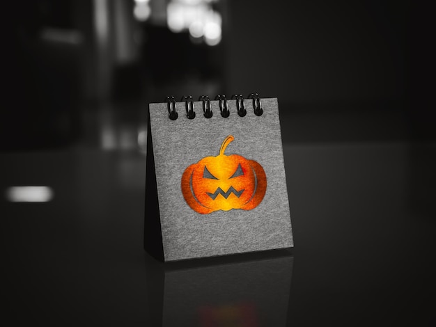 Fröhlicher Halloween-Tageskalender mit glänzendem Kürbis-Grafiksymbol auf schwarzem, klappbarem Tischkalender, der auf dem Schreibtisch auf dunklem Hintergrund steht Trick-or-Treat-Festival-Party- und Feiertagskonzepte