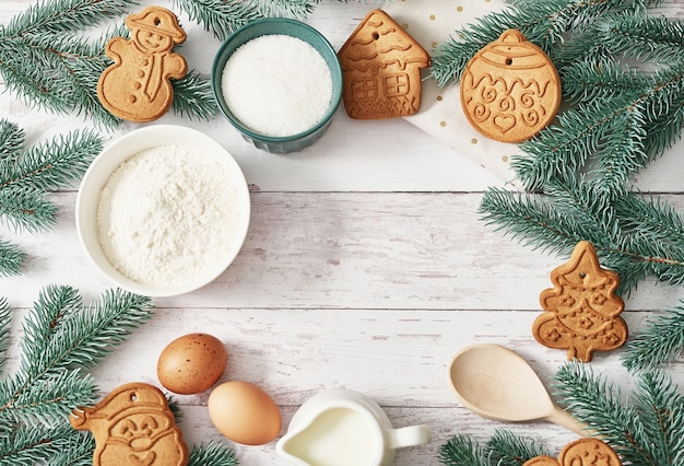 Frohe Weihnachten Hintergrund leckere hausgemachte Ingwer Kekse. Zutaten zum Kochen Backen, Küchenutensilien, Lebkuchen. Frohes neues Jahr Grußkarte. Weihnachtstisch. Tannenbaum, Kiefer.