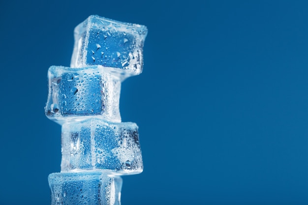 Frostige Eiswürfel in Form eines Turms auf blauem Grund.