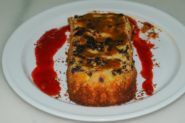 Fruchtschwammkuchen hausgemacht mit Erdbeermarmelade auf weißer Platte