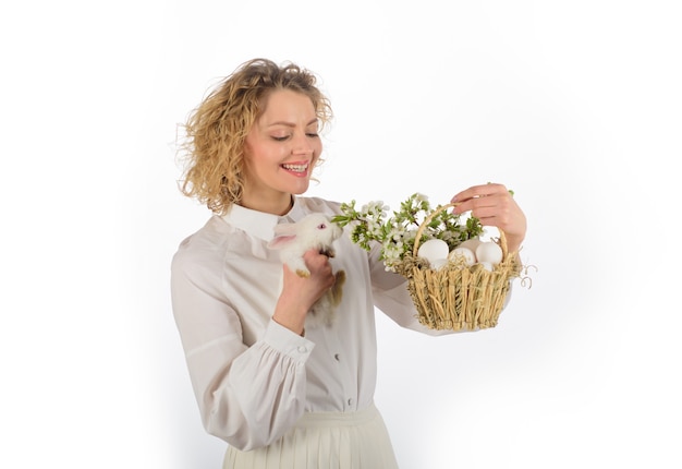 Frühlingsferienkorb mit Eiern Osterei-Häschen Frohe Ostern süße Pelzkaninchen lächelnde Frau
