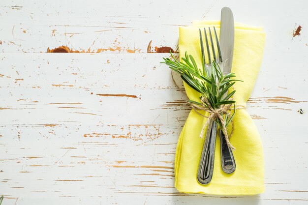 Frühlingsgedeck mit Rosmarin und gelber Serviette