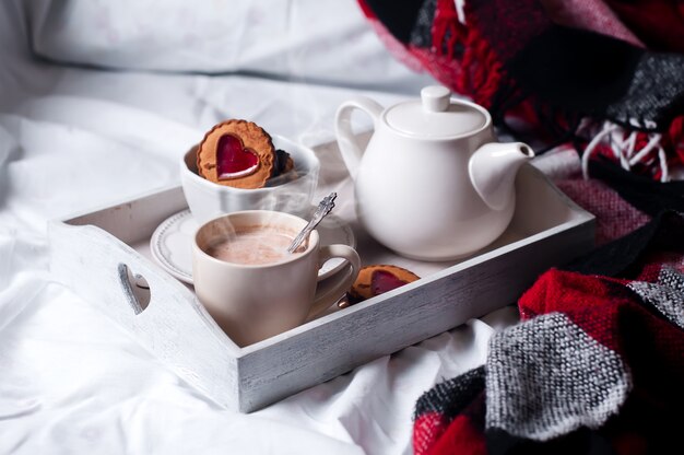 Frühstück im Bett mit Kaffee und Keksen