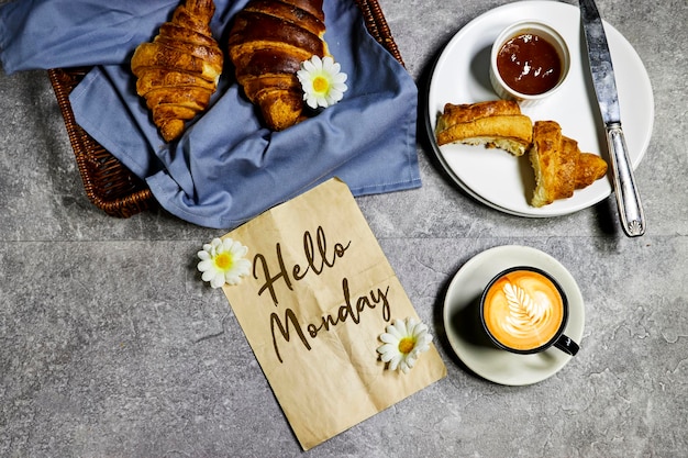 Frühstückskonzept frisches gebackenes Croissant für Frühstück Aprikosenmarmelade und Kaffeetasse mit Blättern später Kunst