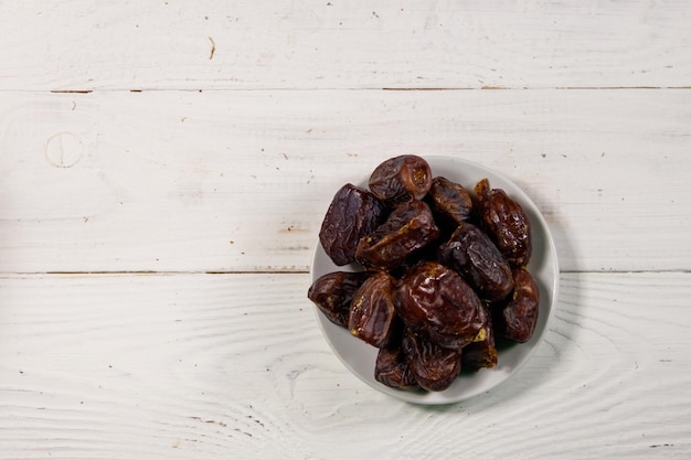 Fruta de dátiles secos en la mesa de madera blanca Vista superior