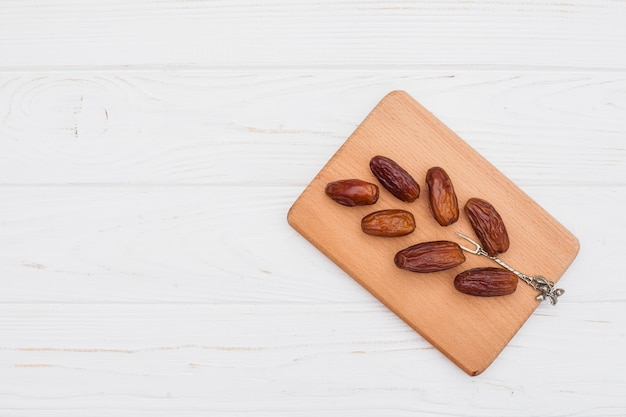 Foto fruta de datas na placa de madeira na mesa