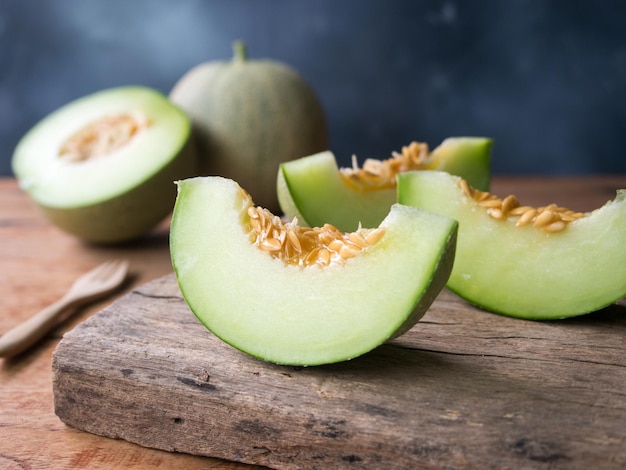 Fruta fresca de melão verde japonês ou melada em mesa de madeira rústica