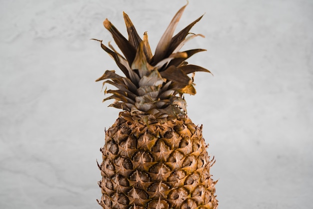 Fruta tropical de abacaxi na mesa de pedra branca.