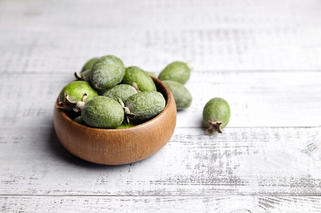 Frutas de feijoa o guayaba de piña en un tazón sobre la mesa de madera gris