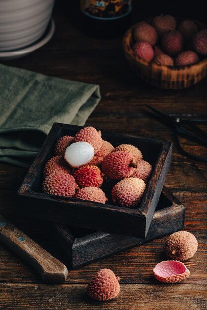 Foto frutas frescas de lichia em caixa de madeira