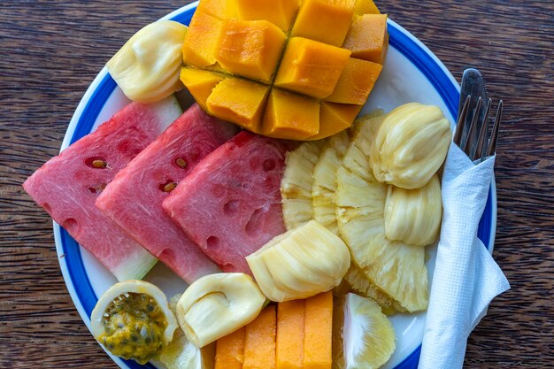 Frutas tropicales en un plato de desayuno vista superior de cerca