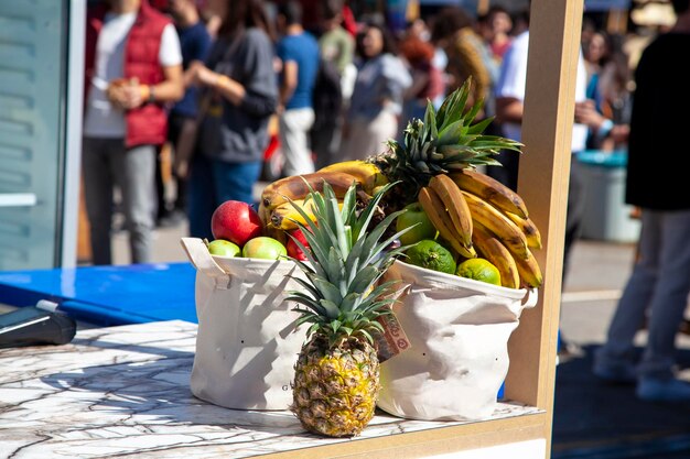 Frutas tropicales de verano en una bolsa de tela. Contador de frutas. Plátano, manzana, piña, mandarina en la bolsa.