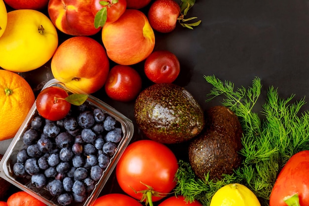 Frutas y verduras saludables sobre fondo negro. Comida dietética o cetogénica.