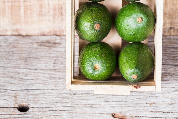 Frutos de aguacate hass sobre fondo de madera