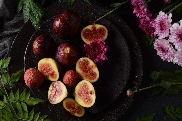 Frutos de figo fresco cru em fundo escuro. Fatias de figo comum fresco (Ficus carica)