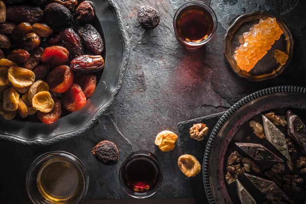 Frutos secos, azúcar de uva y té en espacio libre de pizarra gris.