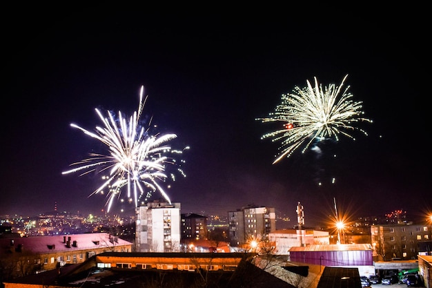 Fuegos artificiales en el cielo nocturno de la ciudad.