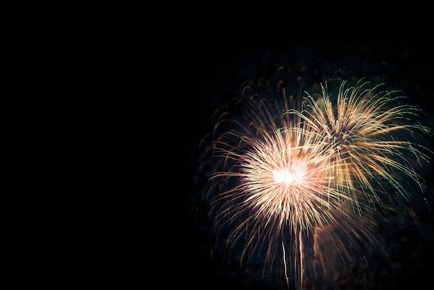 Los fuegos artificiales muestran para la celebración en fondo negro. Concepto de vacaciones de año nuevo.