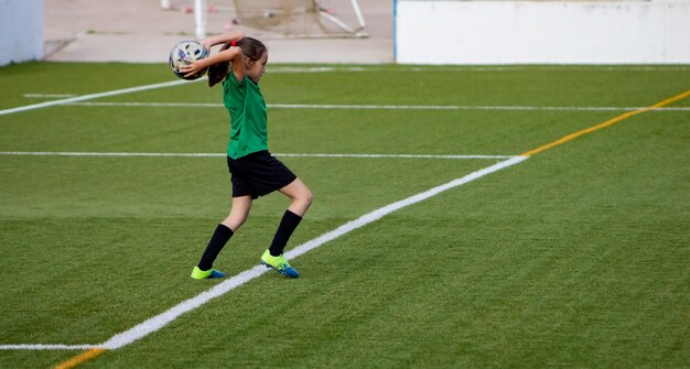 Foto fülle länge von mädchen, das fußball spielt