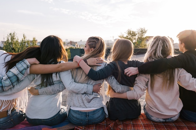 Foto fuerte amistad. pasatiempo feliz afuera. grupo irreconocible de jóvenes, tiempo libre creativo