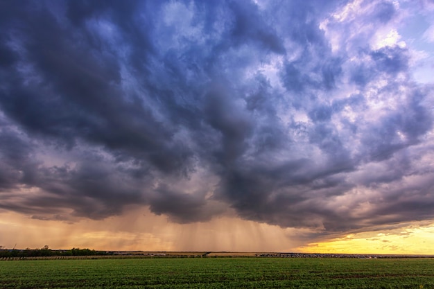 Fuertes lluvias sobre un campo con hermosas nubes de tormenta