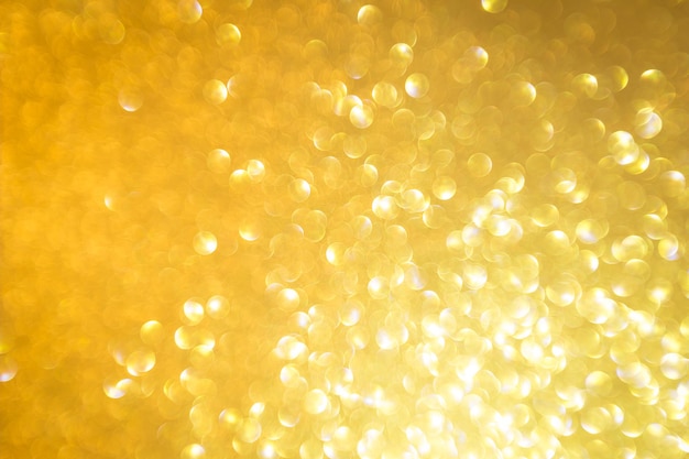 Fundo abstrato com glitter dourado e textura festiva de natal desfocado com luz bokeh