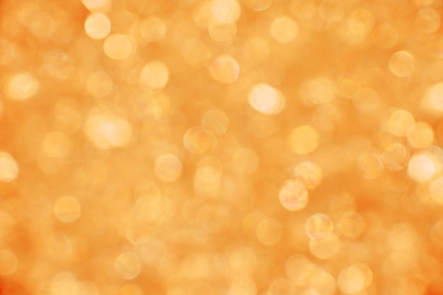 Fundo abstrato de laranja quente de verão e bokeh dourado desfocado luzes desfocadas e brilhos de purpurina