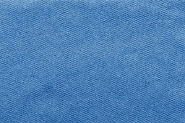 Fundo abstrato e textura de tecido denim ou material têxtil de cor azul pálida