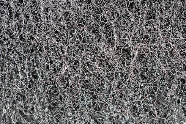 Fundo abstrato escuro e padrão de fios de cabelo entrelaçados, fibras e nanofibras. Textura de detalhe de esponja, textura de esponja perto do fundo. Textura de esponja de celulose. Preto e branco