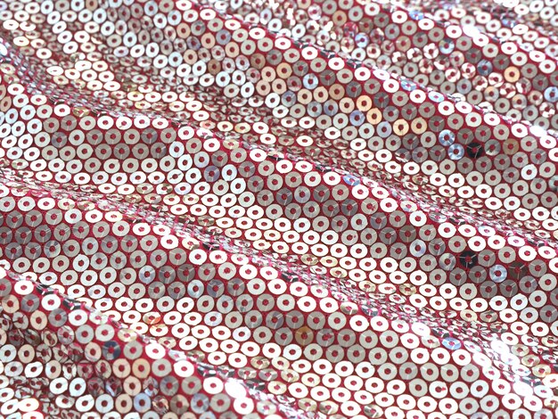 Fundo abstrato que incandesce na tela cor-de-rosa ondulada do sol com lantejoulas de prata.
