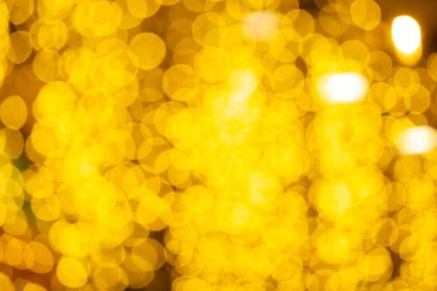 Fundo amarelo borrado do bokeh para o Natal