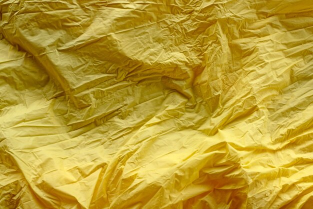 Fundo amarelo rico brilhante abstrato amassado desfocagem têxtil