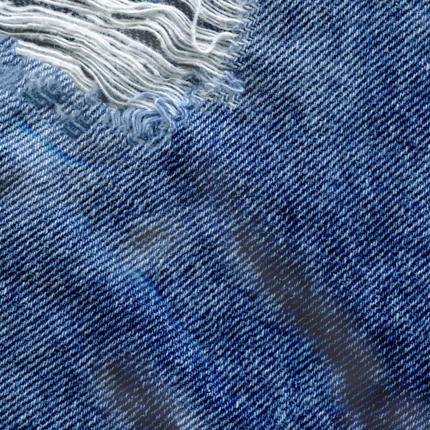 Fundo azul da textura de brim da sarja de Nimes. Textura de tecido rasgado de jeans