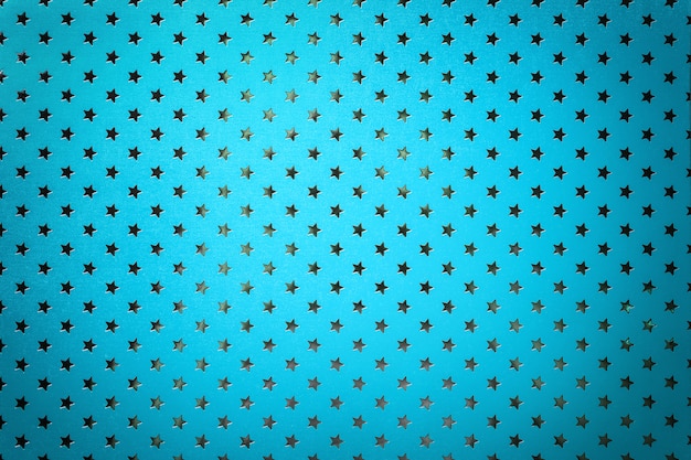 Fundo azul de papel de folha de metal com um padrão de estrelas de prata