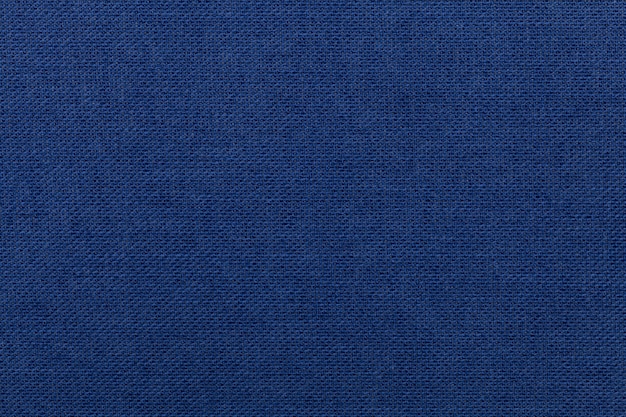 Fundo azul escuro de material têxtil. Tecido com textura natural.