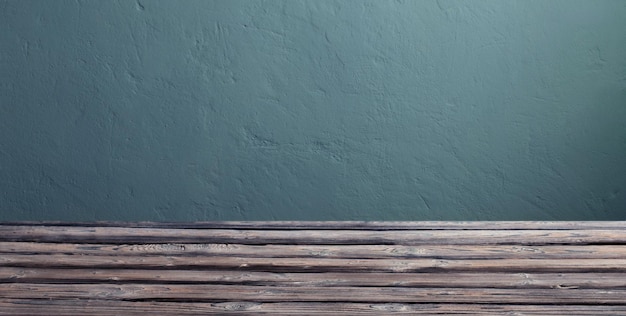 Fundo com mesa de madeira velha e parede verde