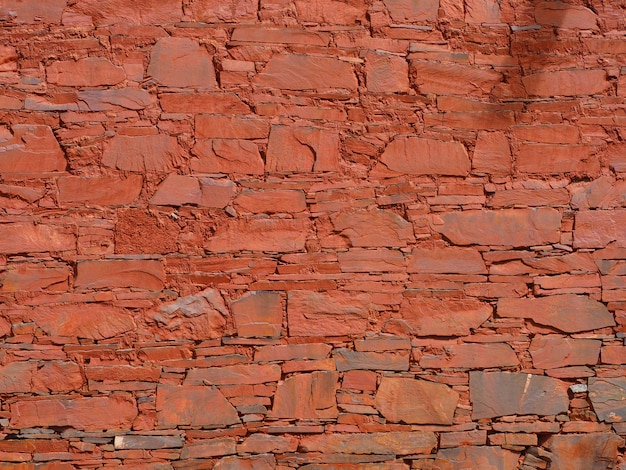 Foto fundo da parede de pedra e fundo da argila vermelha