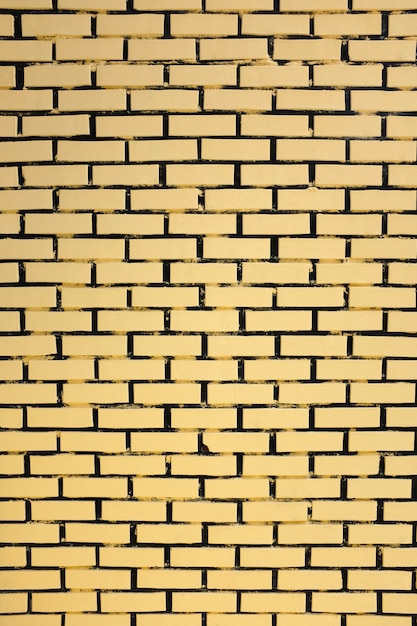 Fundo da parede de tijolo amarelo