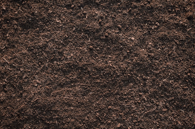 Fundo da textura do solo, solo fértil do barro apropriado para plantar.