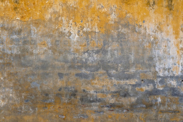 Fundo da velha textura de parede pintada de amarelo