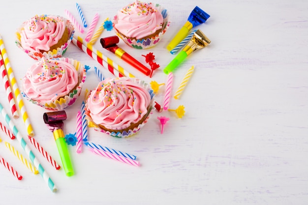 Fundo de aniversário com cupcakes rosa e velas de aniversário