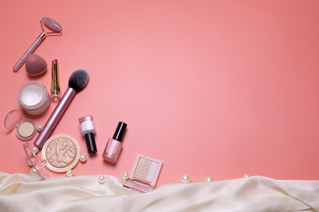 Fundo de beleza rosa com produtos de maquiagem cosmética facial Espaço livre para espaço de cópia de texto