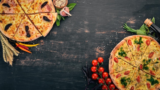 Fundo de comida italiana Variedade de pizza Em um fundo preto de madeira Espaço livre para texto Vista superior